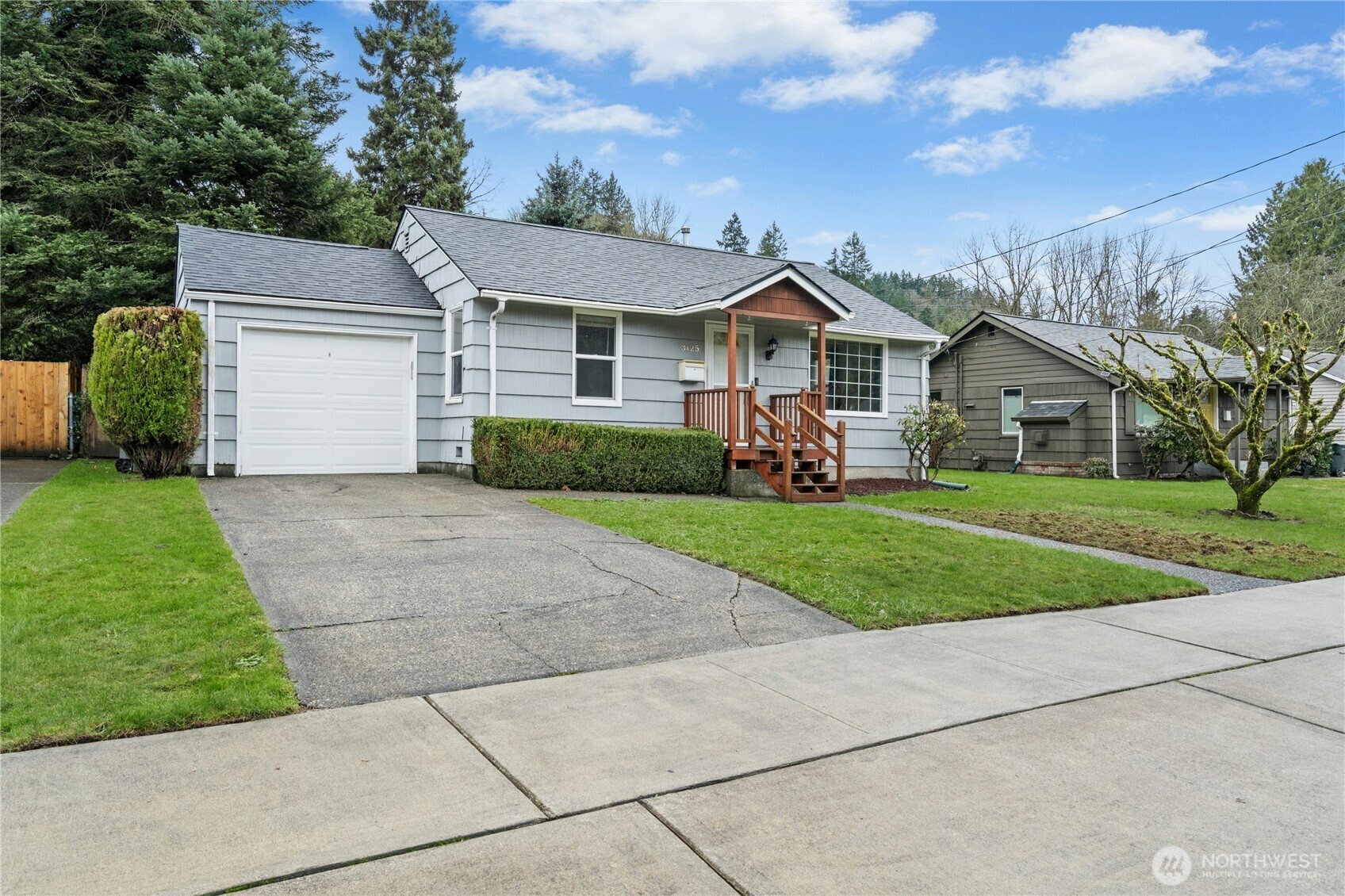 3125 Southeast 6th Street Renton, WA 98058 - Photo 3 of 27 a front view of a house with a yard and garage
