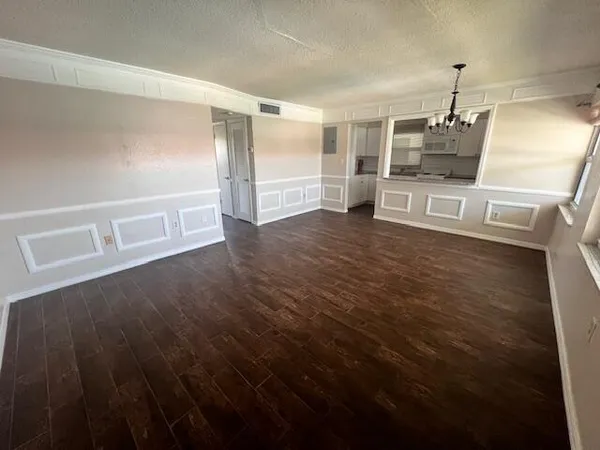 a view of a refrigerator in kitchen and wooden floor