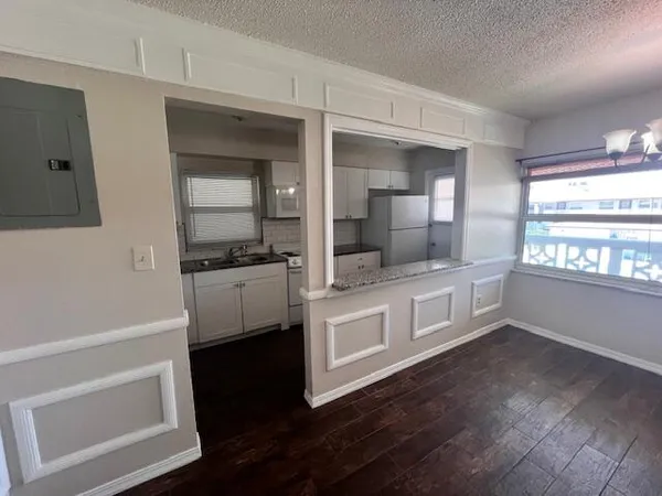 a kitchen with white cabinets and appliances