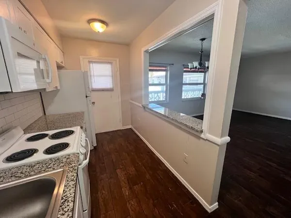 a kitchen with a sink a stove and cabinets
