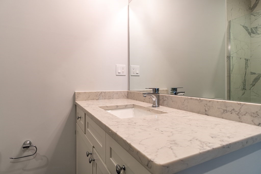 874 South Street, Unit 5 Boston, MA 02131 - Photo 12 of 19 a bathroom with a sink vanity and a mirror