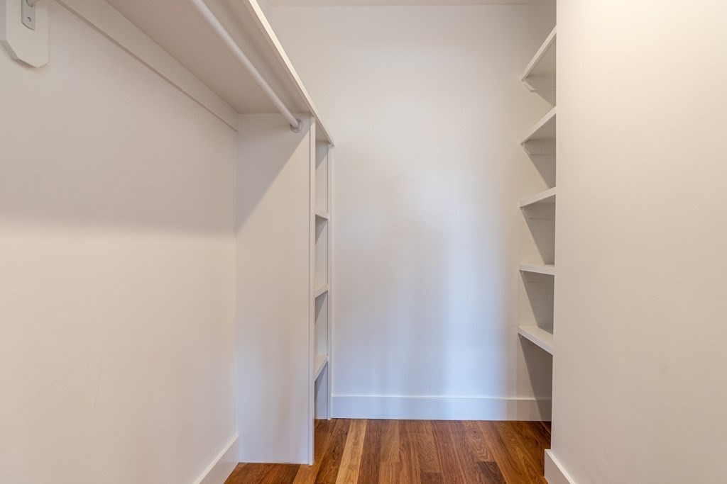 874 South Street, Unit 5 Boston, MA 02131 - Photo 13 of 19 a view of walk in closet with wooden floor