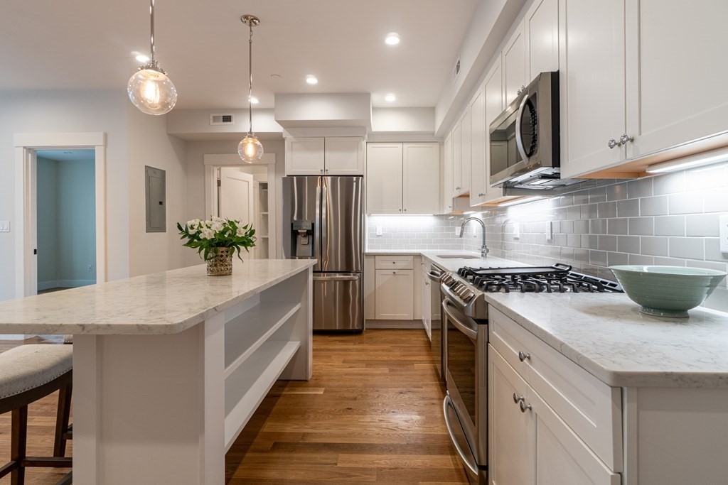 874 South Street, Unit 5 Boston, MA 02131 - Photo 3 of 19 a kitchen with a sink stove and refrigerator