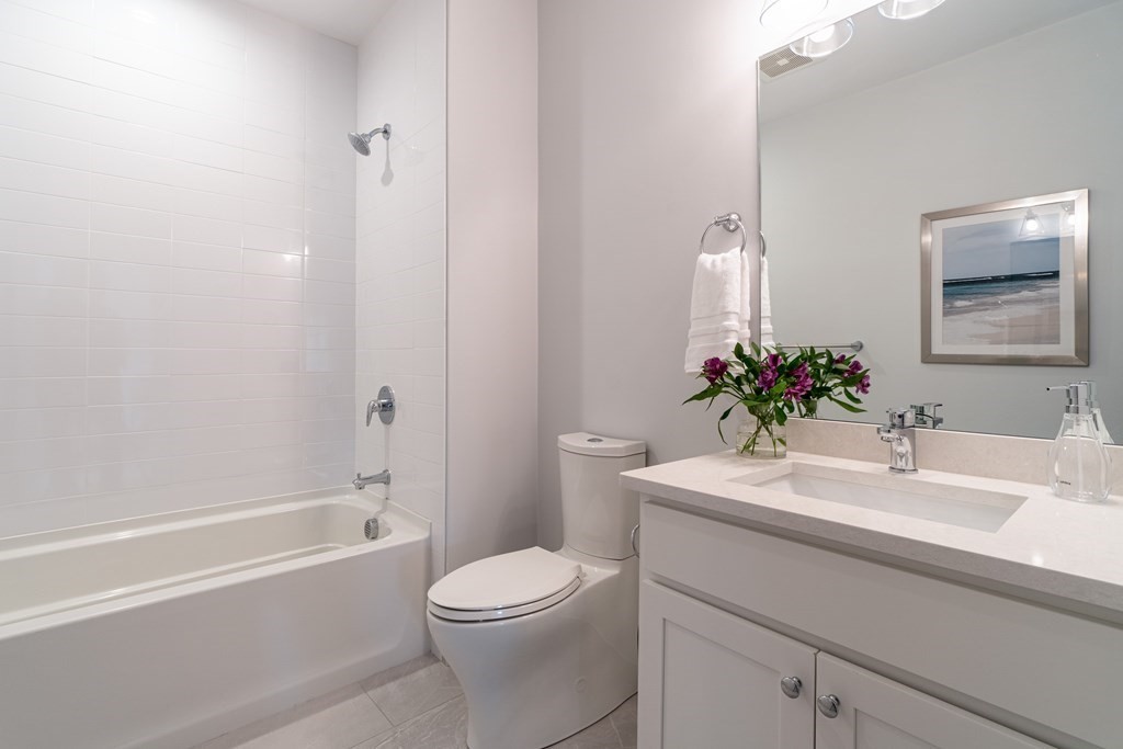 874 South Street, Unit 5 Boston, MA 02131 - Photo 8 of 19 a bathroom with a sink a toilet and shower