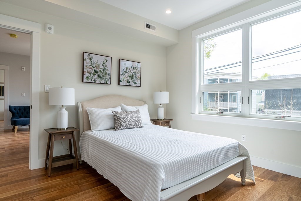 874 South Street, Unit 5 Boston, MA 02131 - Photo 9 of 19 a bedroom with a large bed and a large window