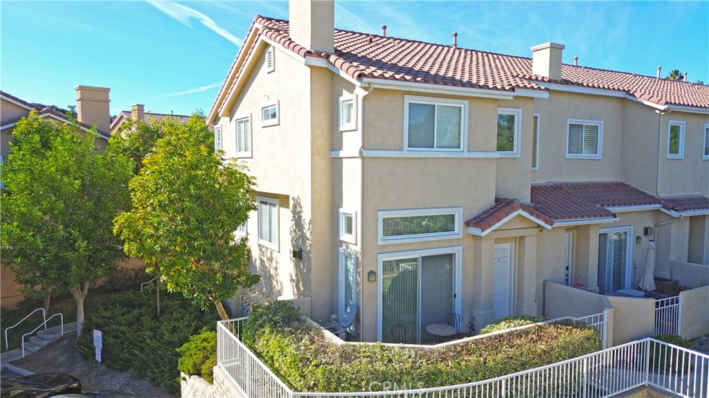 a view of a house with wooden fence