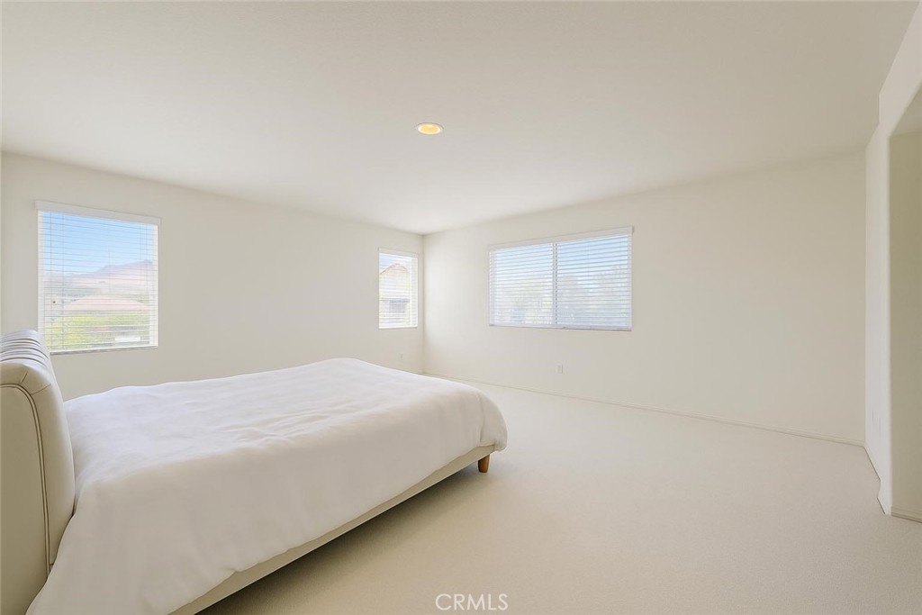 25768 Perlman Place, Unit A Stevenson Ranch, CA 91381 - Photo 12 of 20 a bedroom with a bed and a window
