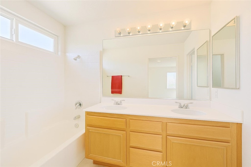 25768 Perlman Place, Unit A Stevenson Ranch, CA 91381 - Photo 13 of 20 a bathroom with a sink and a mirror