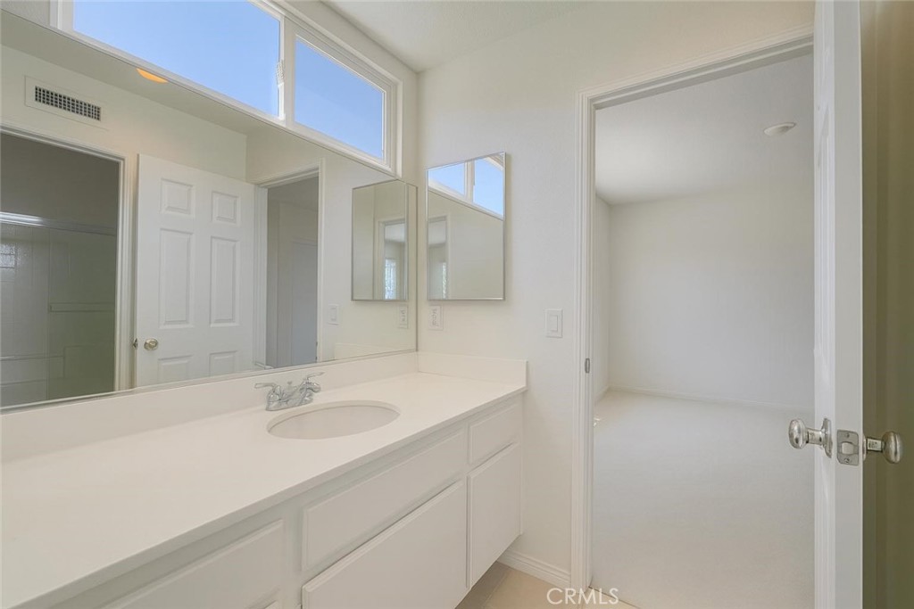 25768 Perlman Place, Unit A Stevenson Ranch, CA 91381 - Photo 15 of 20 a bathroom with a sink and a mirror