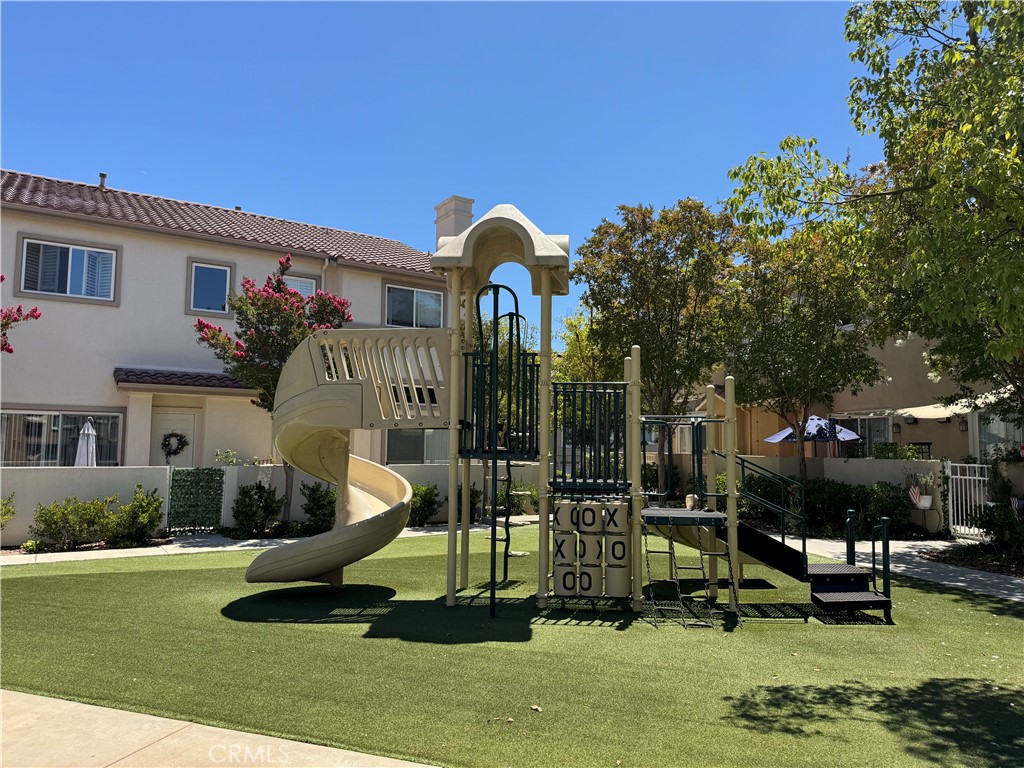 25768 Perlman Place, Unit A Stevenson Ranch, CA 91381 - Photo 20 of 20 a swimming pool with outdoor seating and yard