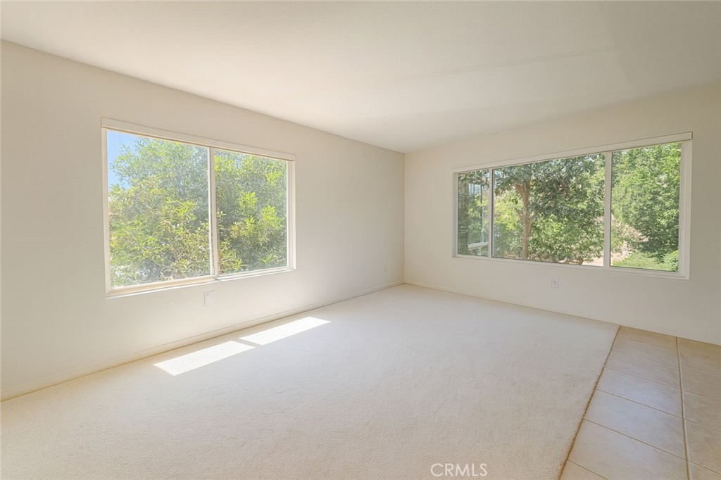 25768 Perlman Place, Unit A Stevenson Ranch, CA 91381 - Photo 3 of 20 an empty room with windows