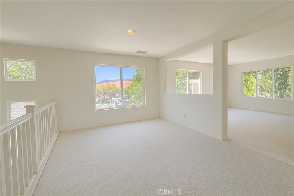 25768 Perlman Place, Unit A Stevenson Ranch, CA 91381 - Photo 7 of 20 an empty room with windows