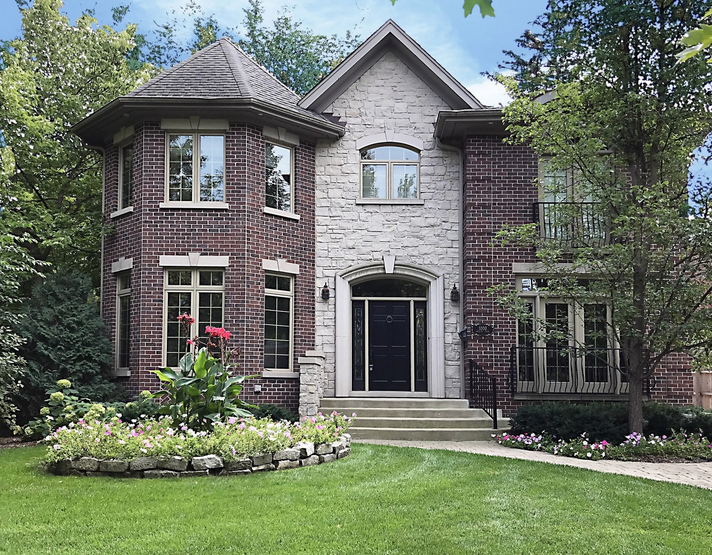 a front view of a house with a garden and plants