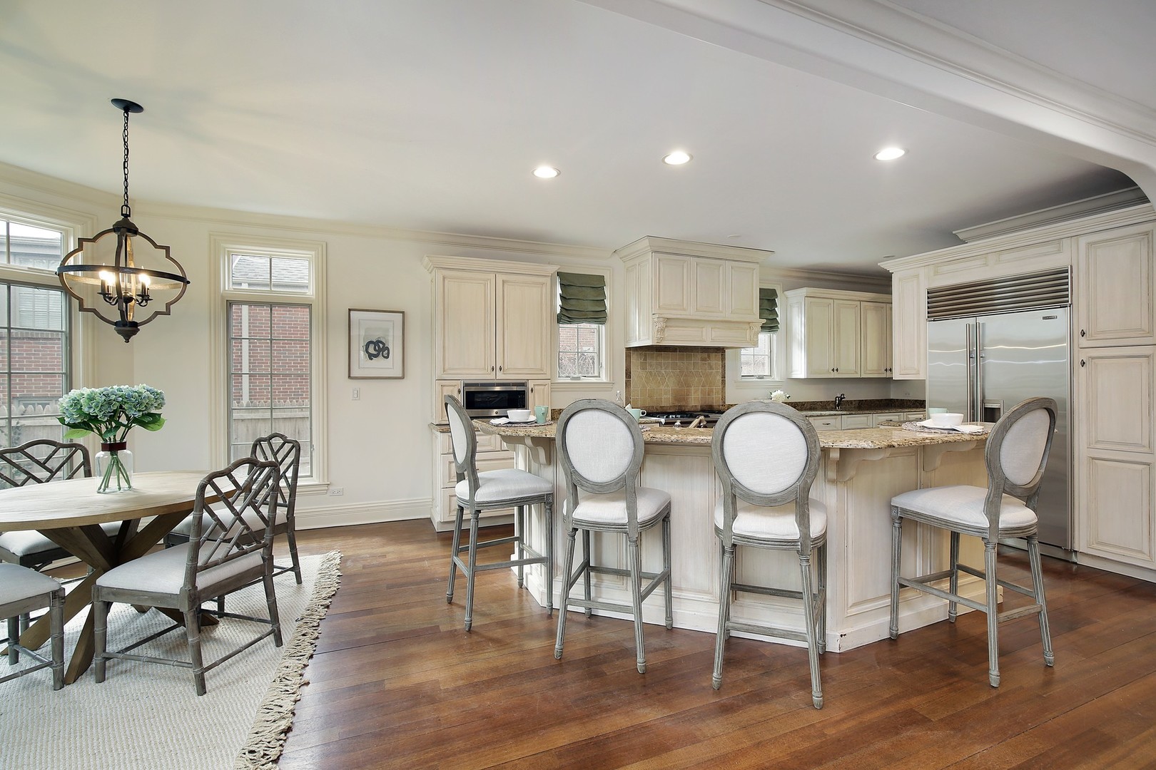 1000 Willow Road Winnetka, IL 60093 - Photo 8 of 26 a dining room filled chandelier and wooden floor