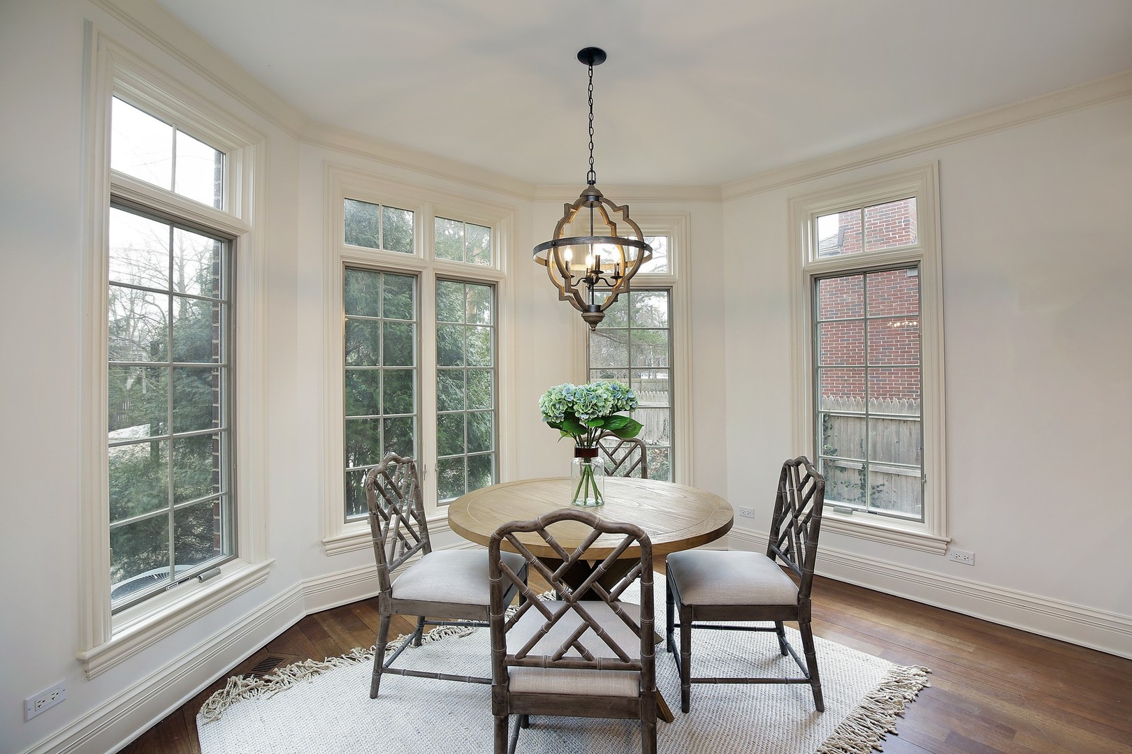 1000 Willow Road Winnetka, IL 60093 - Photo 9 of 26 a dining room with furniture a chandelier and wooden floor