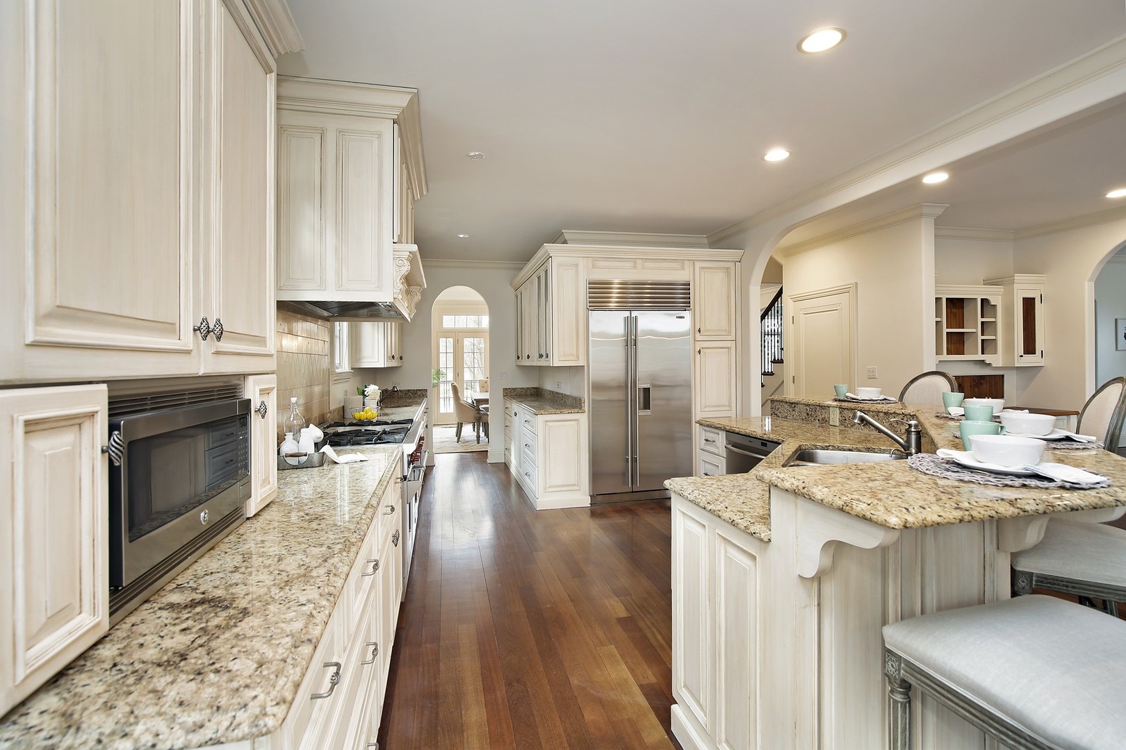 1000 Willow Road Winnetka, IL 60093 - Photo 10 of 26 a open kitchen with sink cabinets and a wooden floor