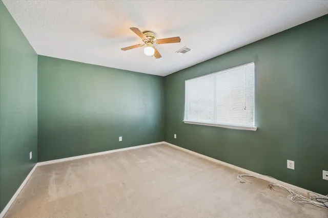 a view of a ceiling fan and a window