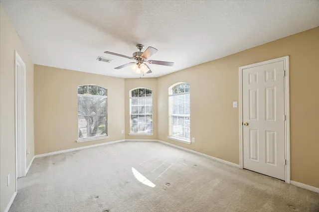 an empty room with windows and closet