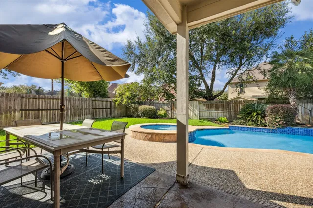 a view of yard with swimming pool and sitting area