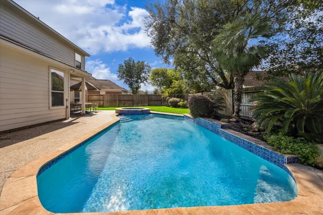 a view of a backyard with swimming pool