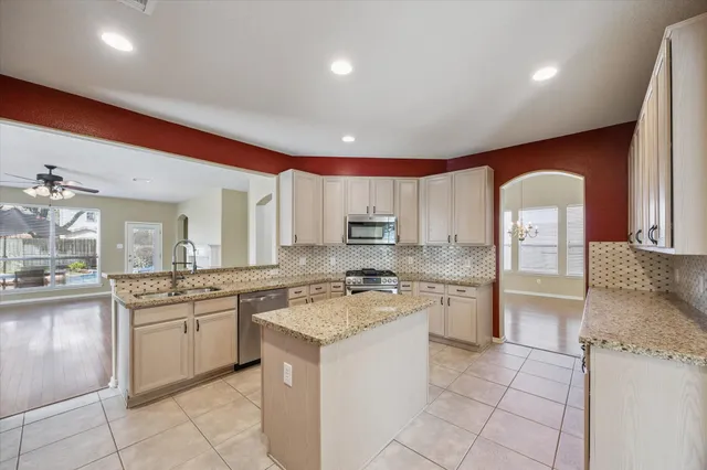 a kitchen with a sink stove and cabinets