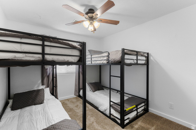 664 East Springhill Drive Washington, UT 84780 - Photo 12 of 21 Bedroom featuring light brown carpeting and white walls