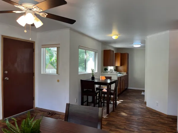 a view of a dining room with furniture window and wooden floor