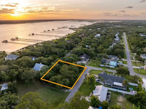 an aerial view of house with yard swimming pool and ocean view