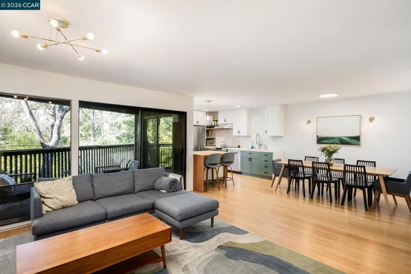a living room with furniture wooden floor and a large window