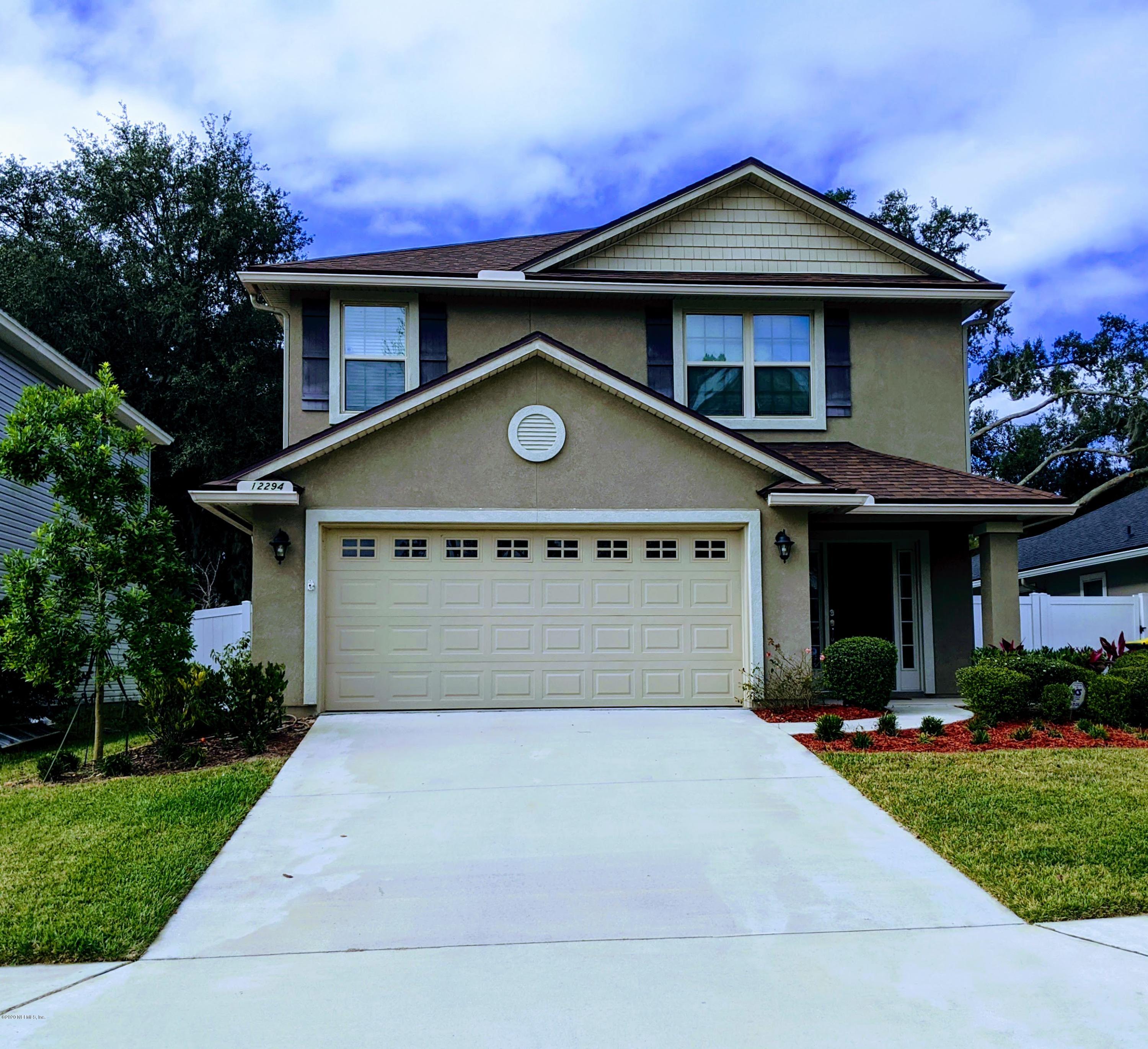 12294 Rouen Cove Drive Jacksonville, FL 32226 - Photo 1 of 41 a front view of a house with a yard and garage