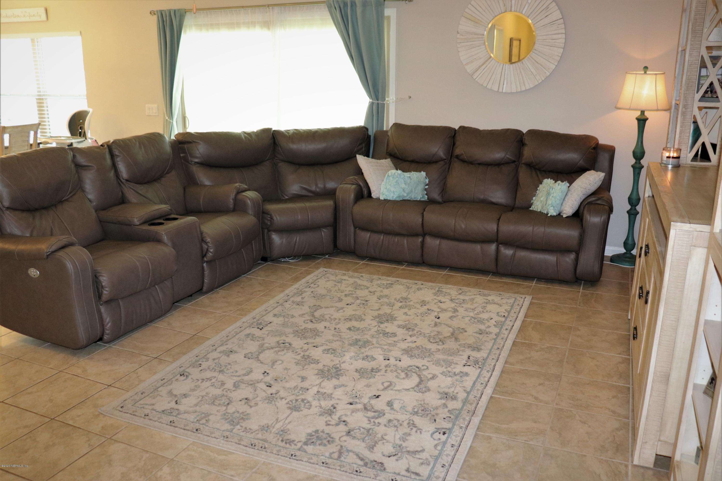 12294 Rouen Cove Drive Jacksonville, FL 32226 - Photo 12 of 41 a living room with furniture and a large window