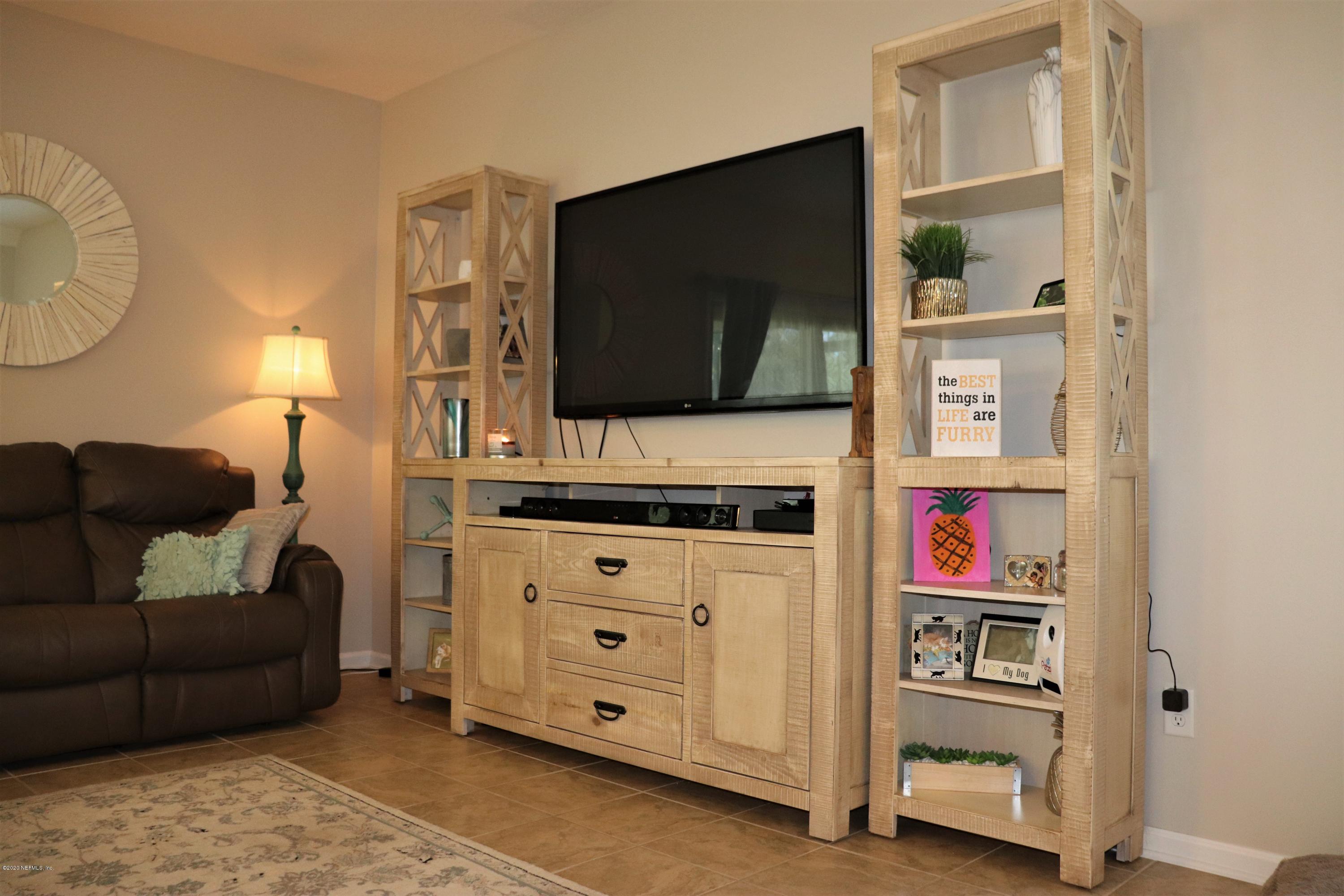 12294 Rouen Cove Drive Jacksonville, FL 32226 - Photo 14 of 41 a living room with furniture and a flat screen tv