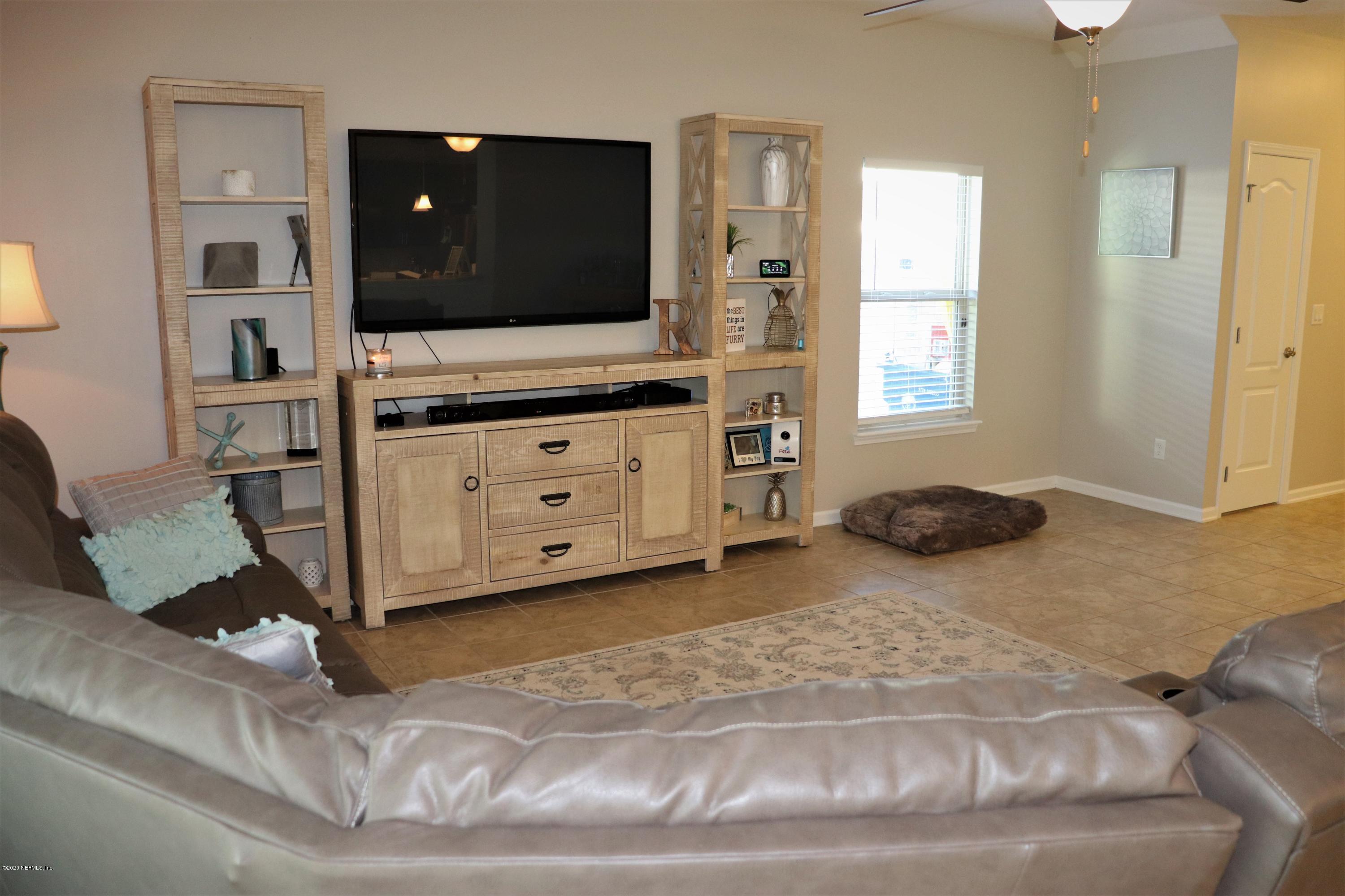 12294 Rouen Cove Drive Jacksonville, FL 32226 - Photo 15 of 41 a living room with furniture and a flat screen tv
