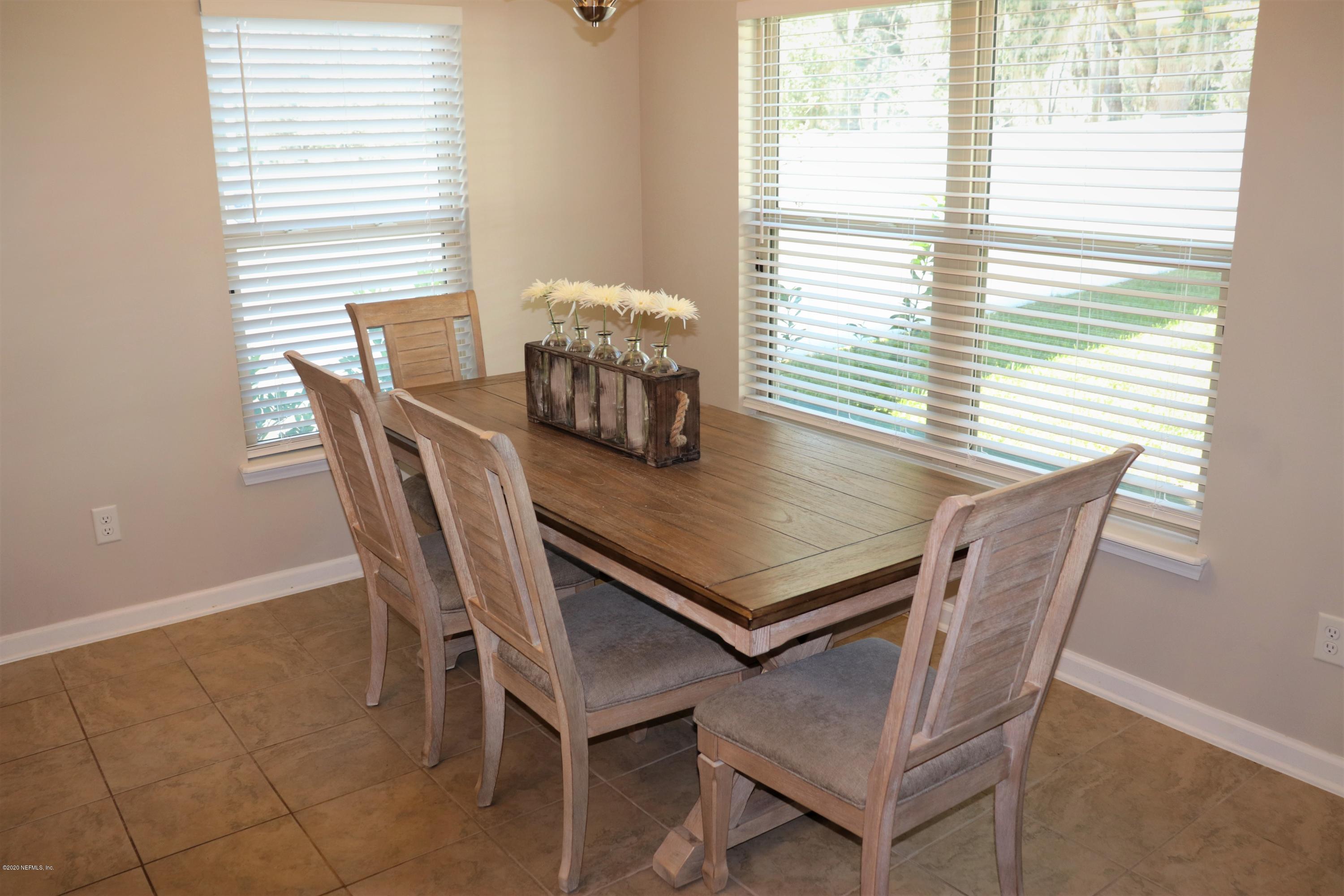 12294 Rouen Cove Drive Jacksonville, FL 32226 - Photo 16 of 41 a view of a dining table and chairs in a room