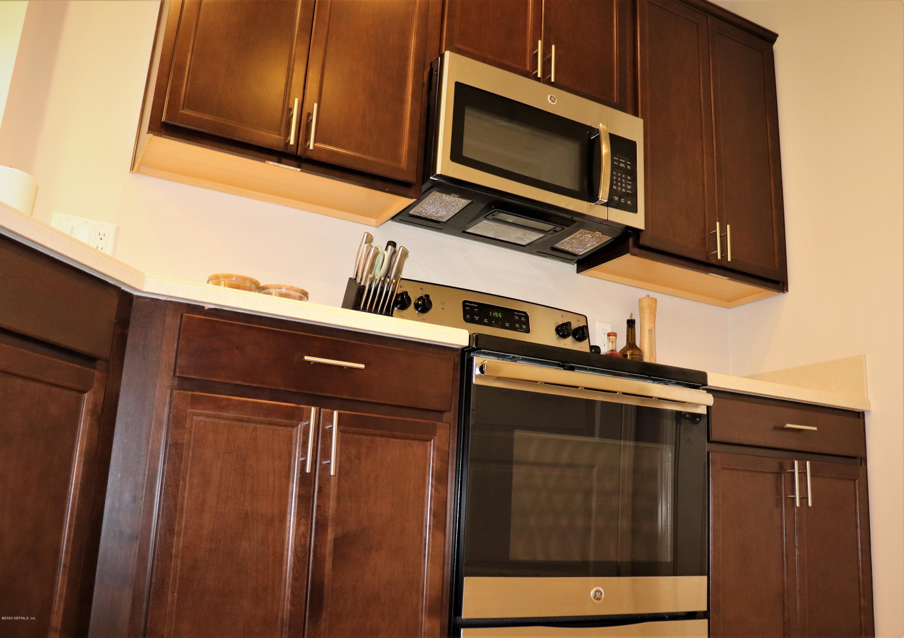 12294 Rouen Cove Drive Jacksonville, FL 32226 - Photo 20 of 41 a kitchen with granite countertop cabinets stainless steel appliances and a counter space