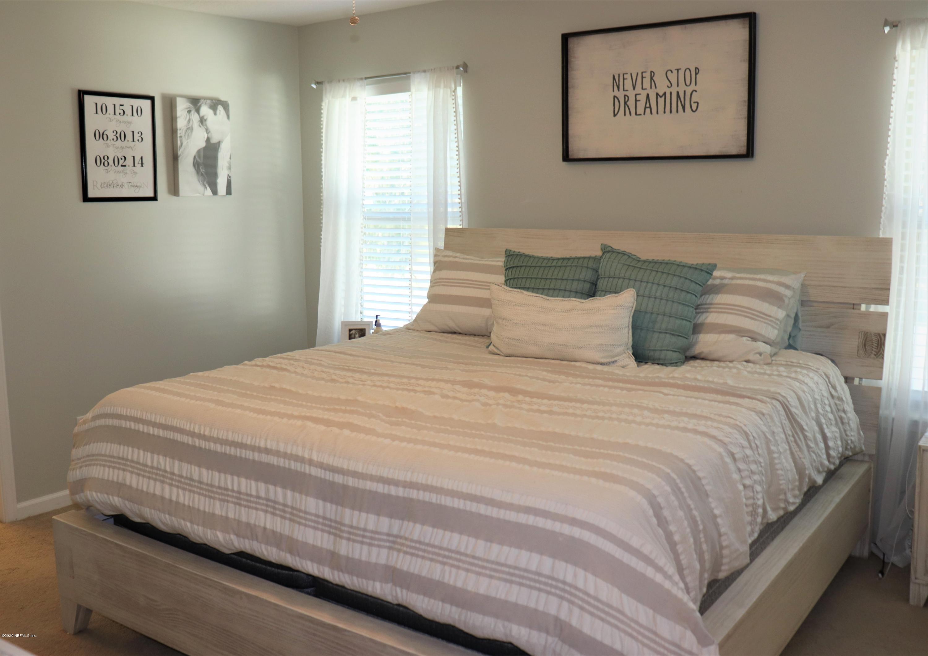 12294 Rouen Cove Drive Jacksonville, FL 32226 - Photo 26 of 41 a bedroom with bed and wall painting