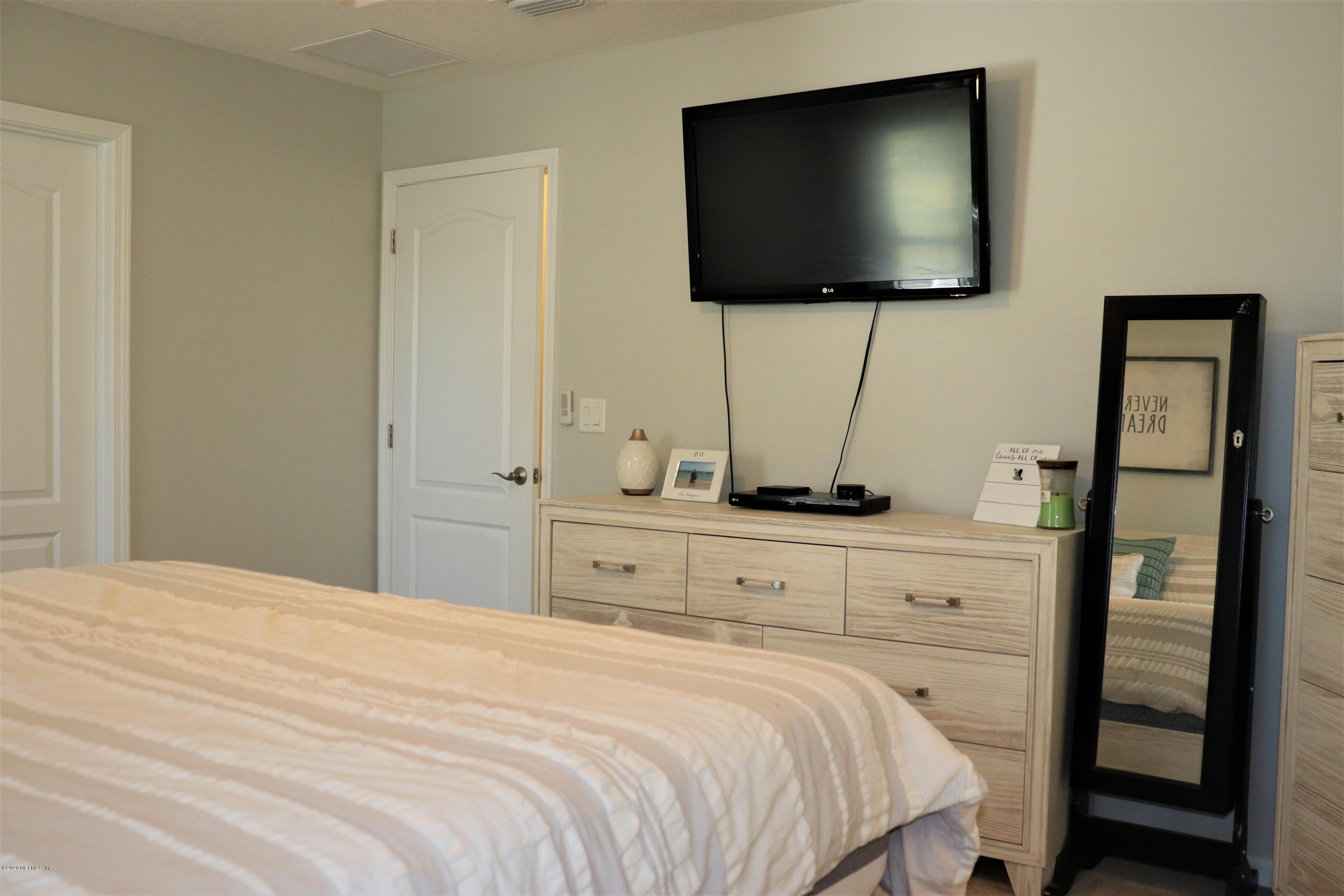 12294 Rouen Cove Drive Jacksonville, FL 32226 - Photo 27 of 41 a bedroom with a bed and a flat screen tv