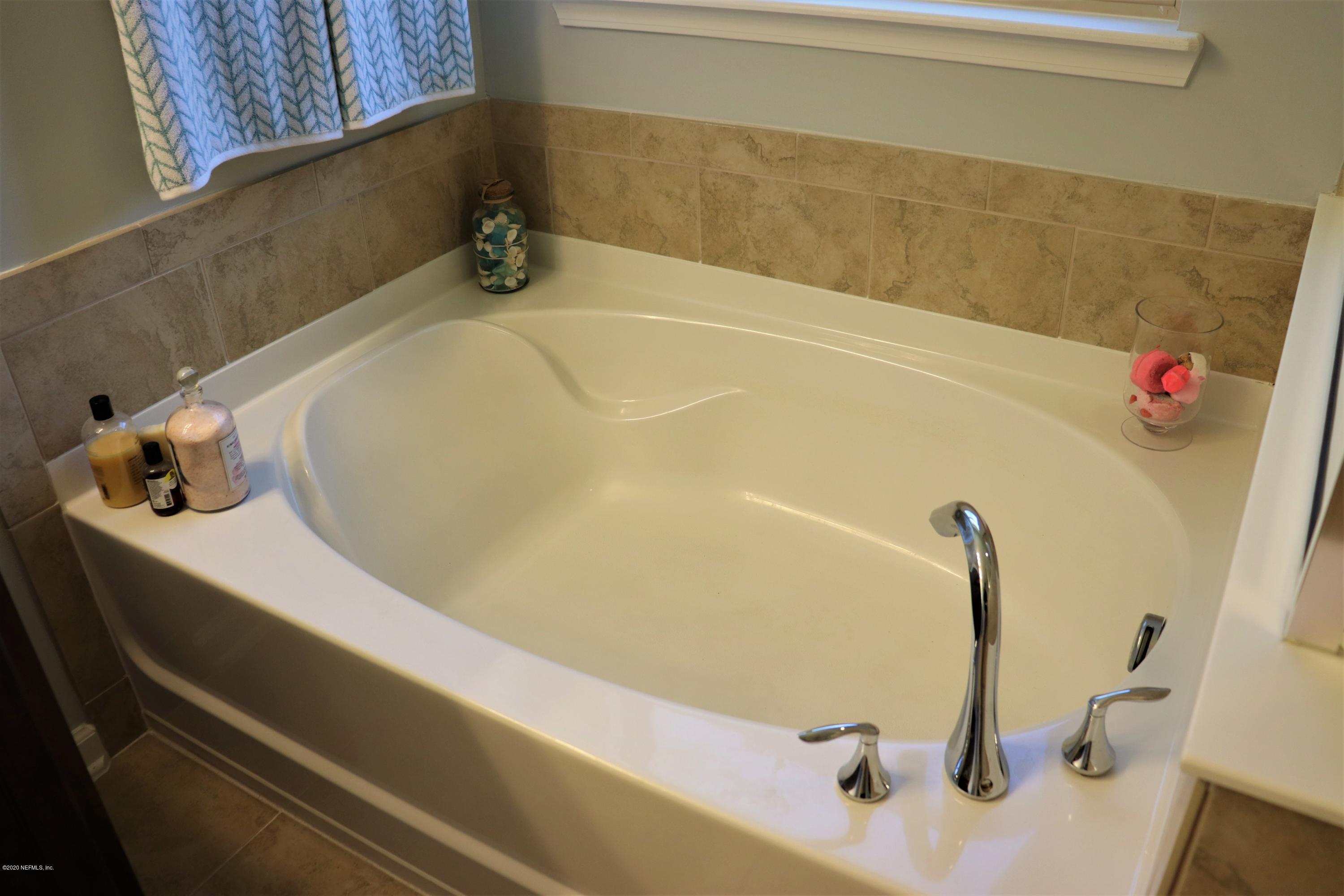 12294 Rouen Cove Drive Jacksonville, FL 32226 - Photo 29 of 41 a bathroom with a bathtub