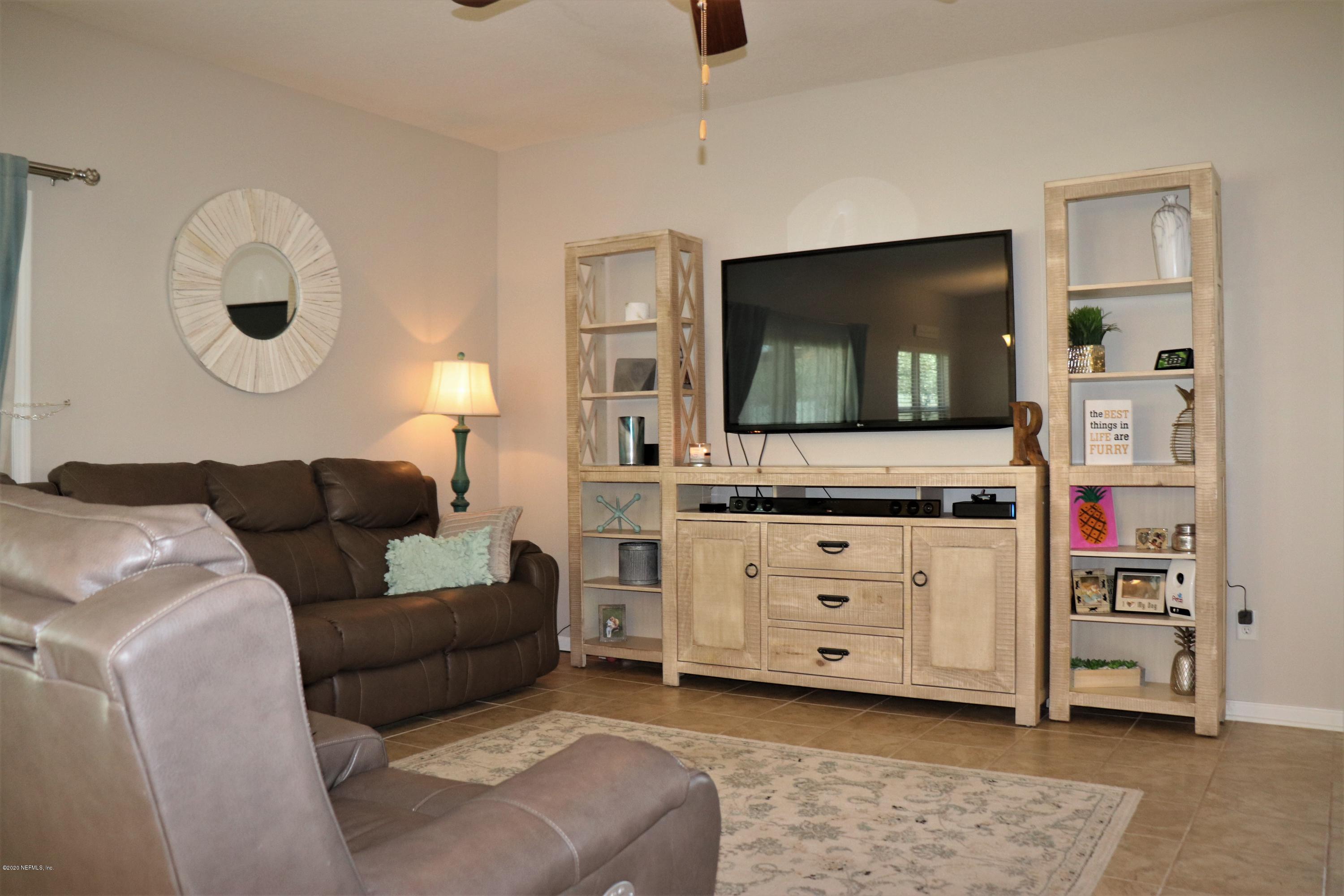 12294 Rouen Cove Drive Jacksonville, FL 32226 - Photo 3 of 41 a living room with furniture and a flat screen tv