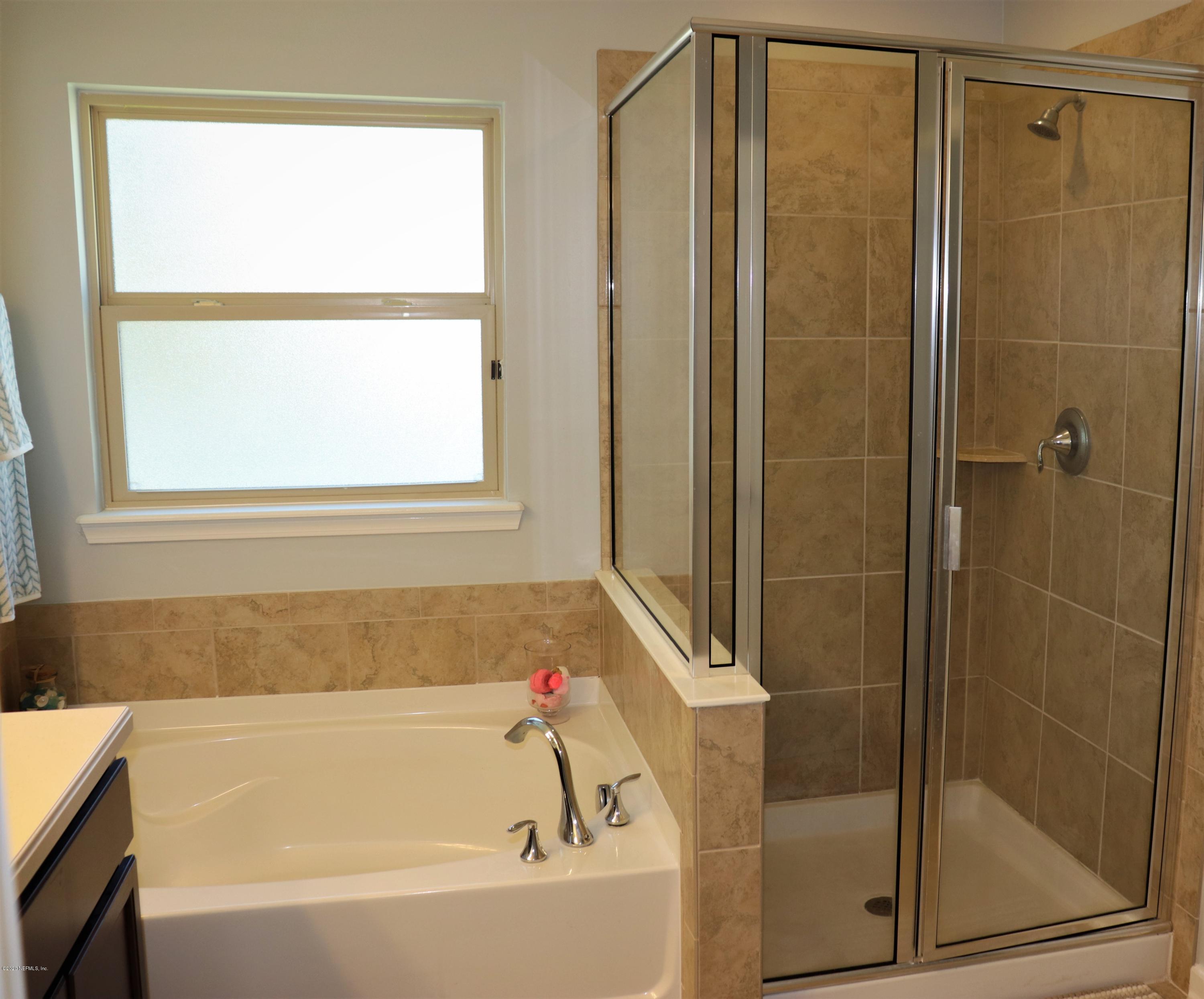 12294 Rouen Cove Drive Jacksonville, FL 32226 - Photo 32 of 41 a bathroom with a bathtub and a shower