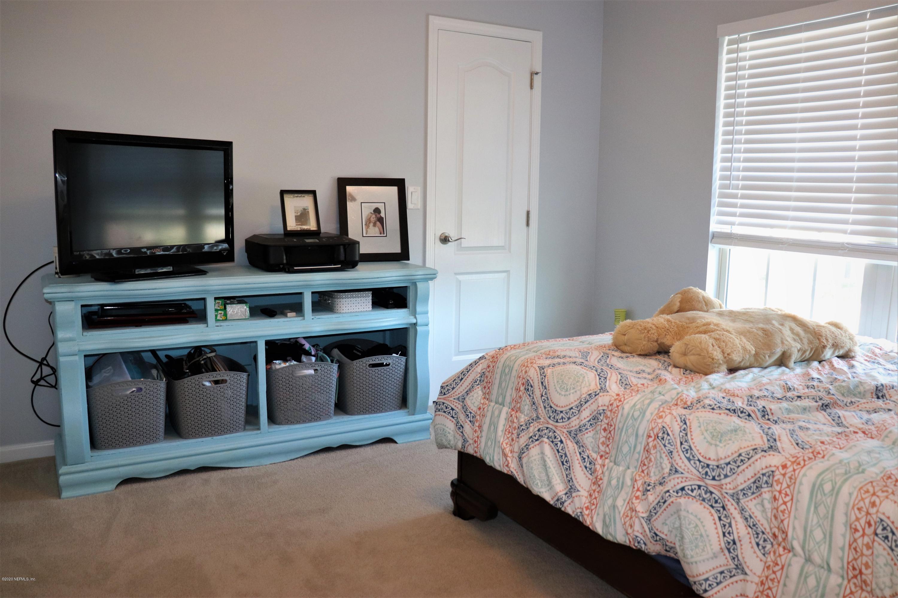 12294 Rouen Cove Drive Jacksonville, FL 32226 - Photo 33 of 41 a bedroom with a bed and a flat screen tv