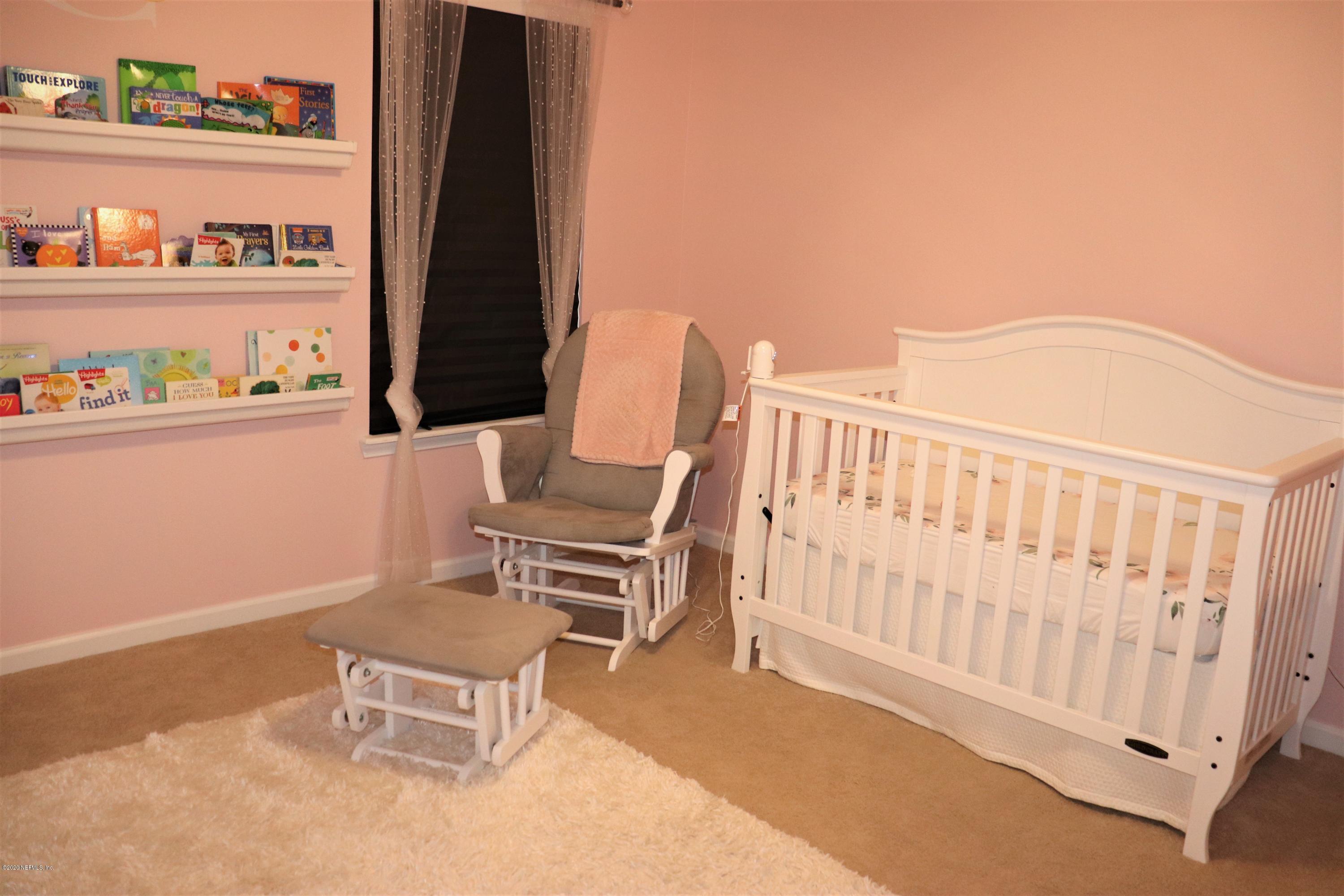 12294 Rouen Cove Drive Jacksonville, FL 32226 - Photo 34 of 41 a bedroom with a bed and a window