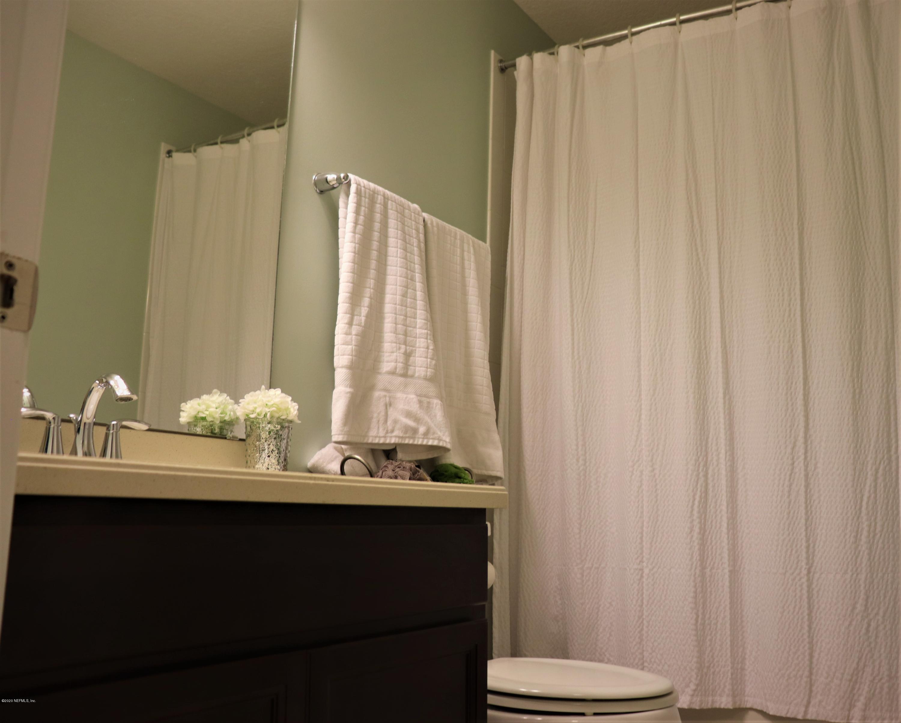12294 Rouen Cove Drive Jacksonville, FL 32226 - Photo 35 of 41 a bathroom with a sink and a mirror