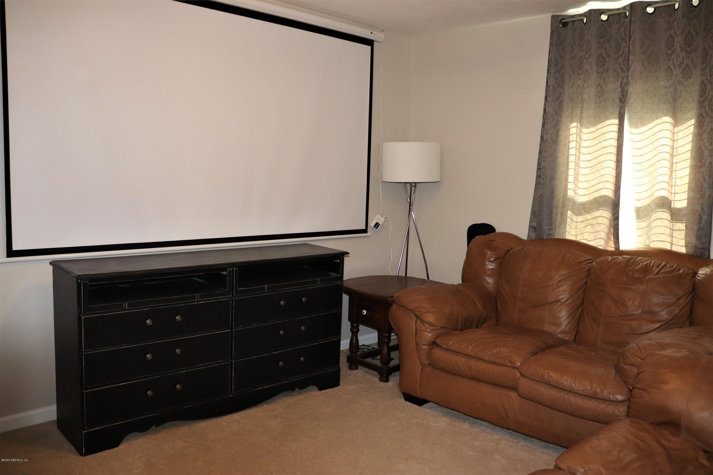 12294 Rouen Cove Drive Jacksonville, FL 32226 - Photo 37 of 41 a living room with furniture and a lamp