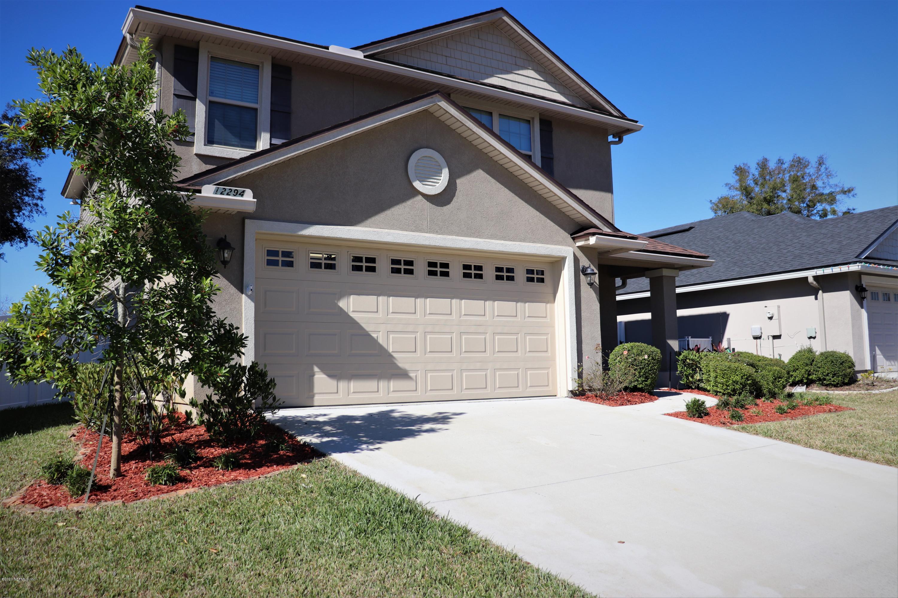 12294 Rouen Cove Drive Jacksonville, FL 32226 - Photo 7 of 41 a front view of a house with a yard and garage