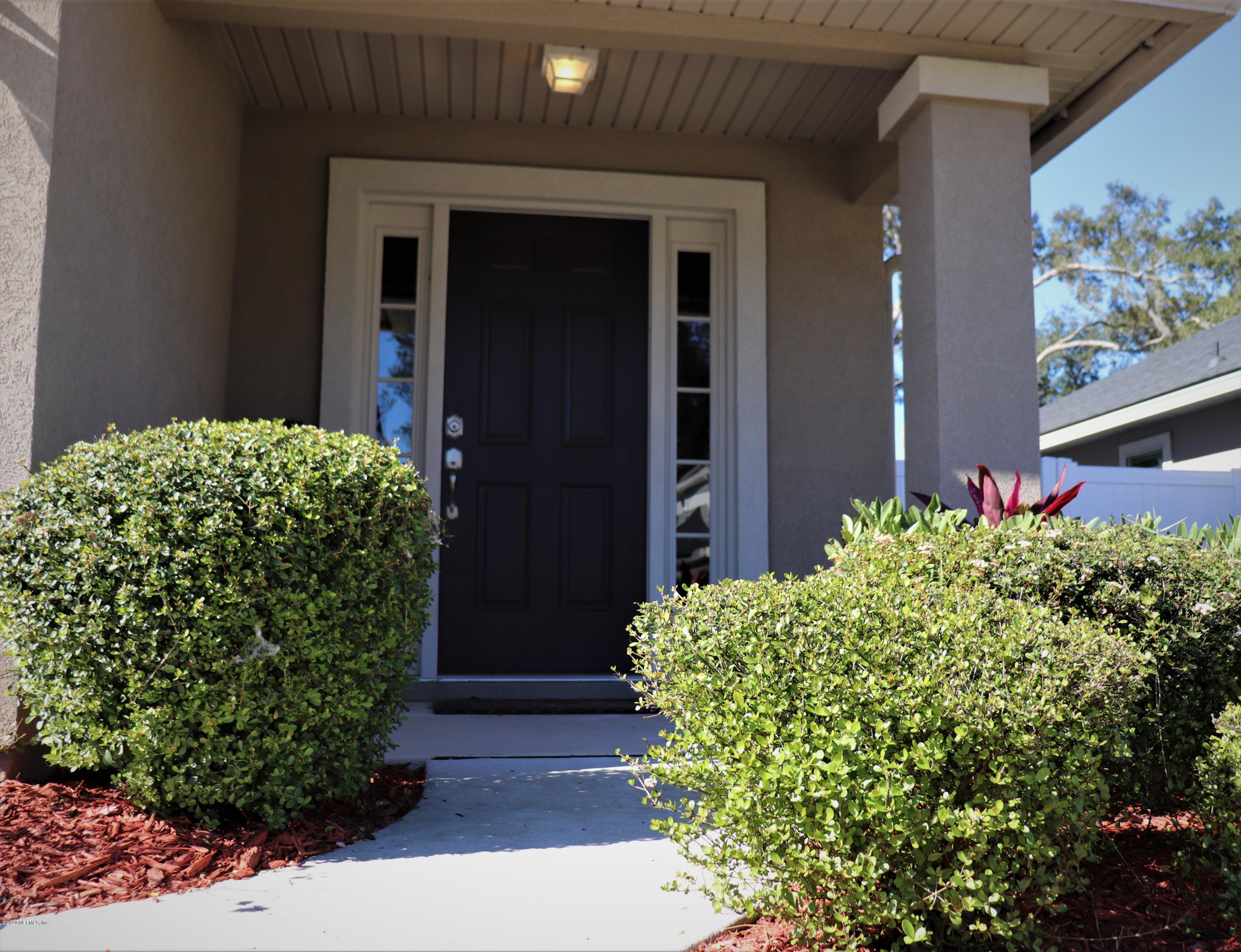 12294 Rouen Cove Drive Jacksonville, FL 32226 - Photo 10 of 41 a couple of flowers in front of a door
