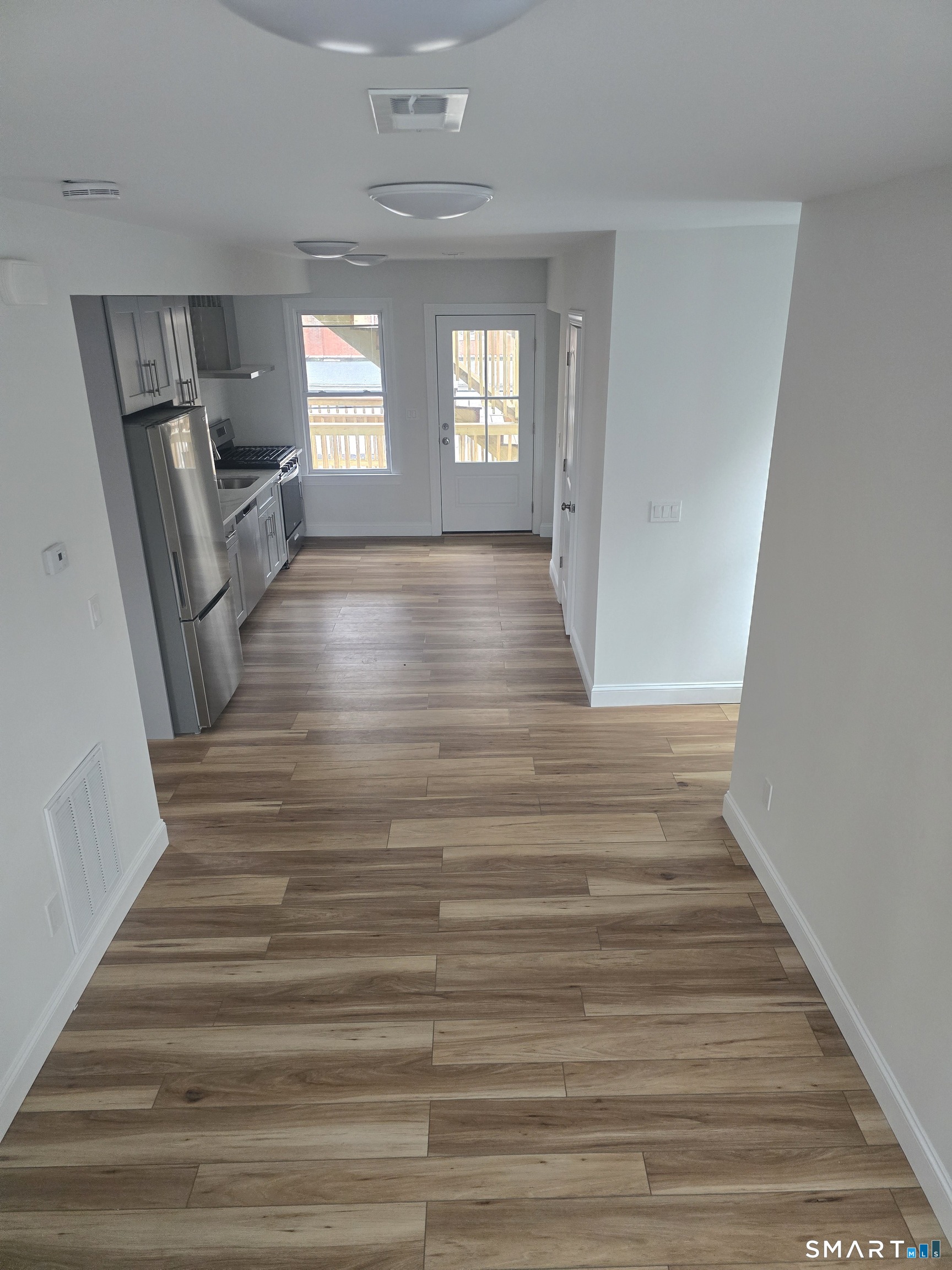 530 Jane Street, Unit 2 Bridgeport, CT 06608 - Photo 4 of 9 a view of a hallway view with wooden floor and staircase