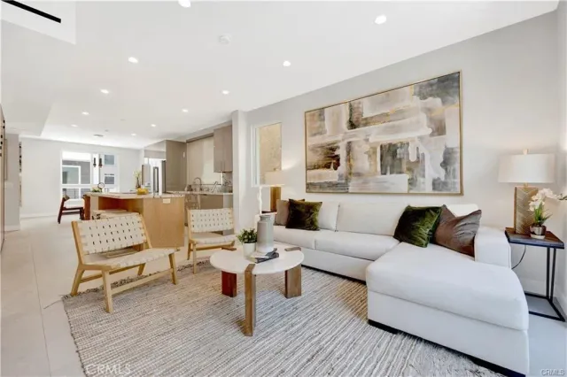 a living room with furniture and a painting on the wall