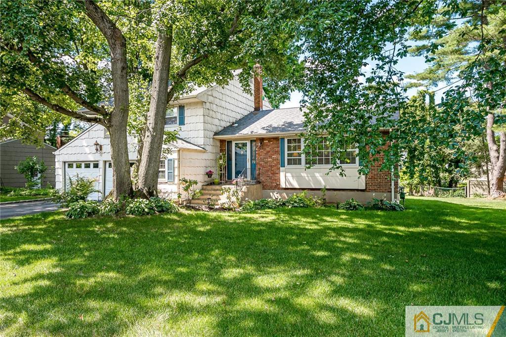 72 Monroe Avenue Edison, NJ 08820 - Photo 1 of 35 a front view of a house with a yard and trees