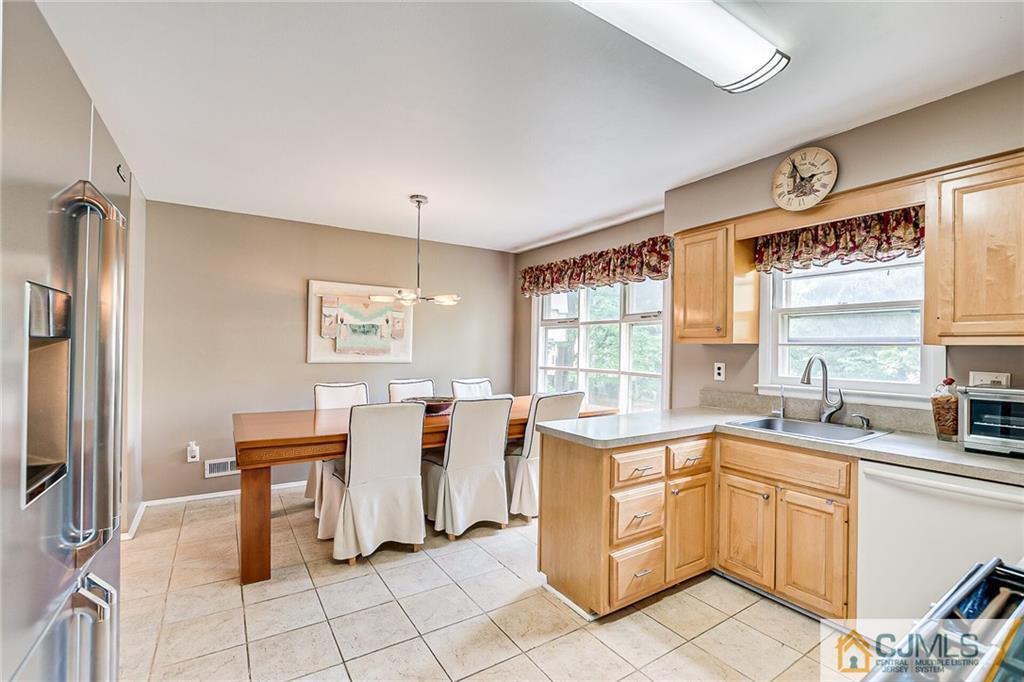 72 Monroe Avenue Edison, NJ 08820 - Photo 12 of 35 a kitchen with a sink window and chairs